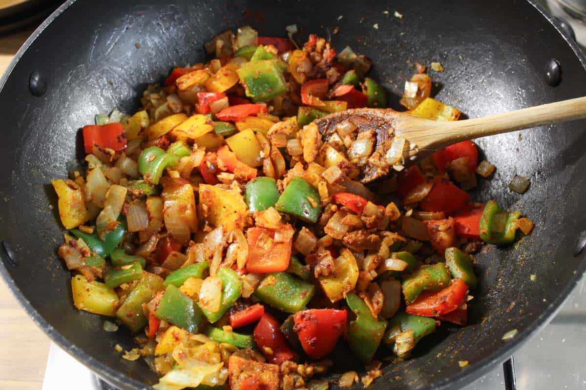 Recipe Process Shot – Stirring Chilli Spices into Fried Veg