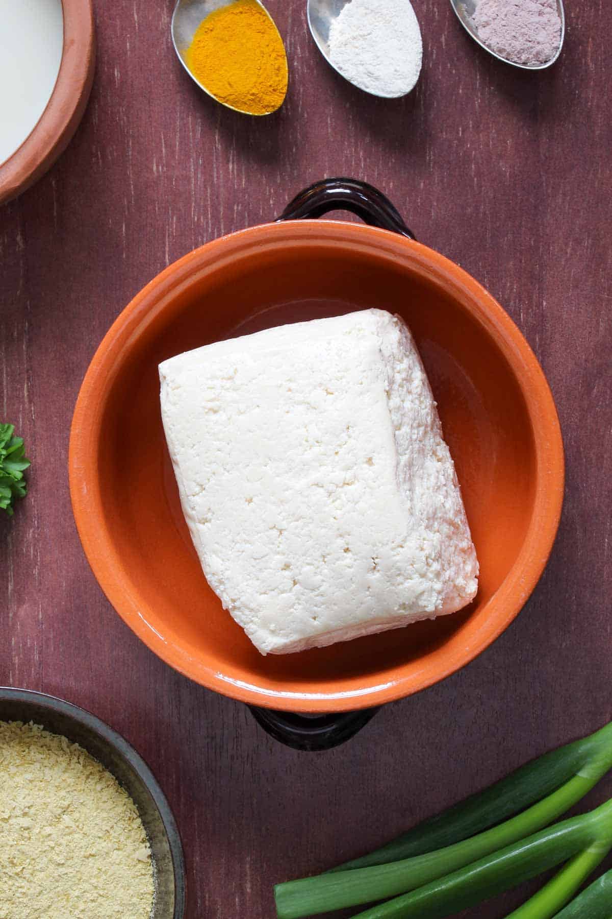 Vegan-friendly tofu block in bowl.