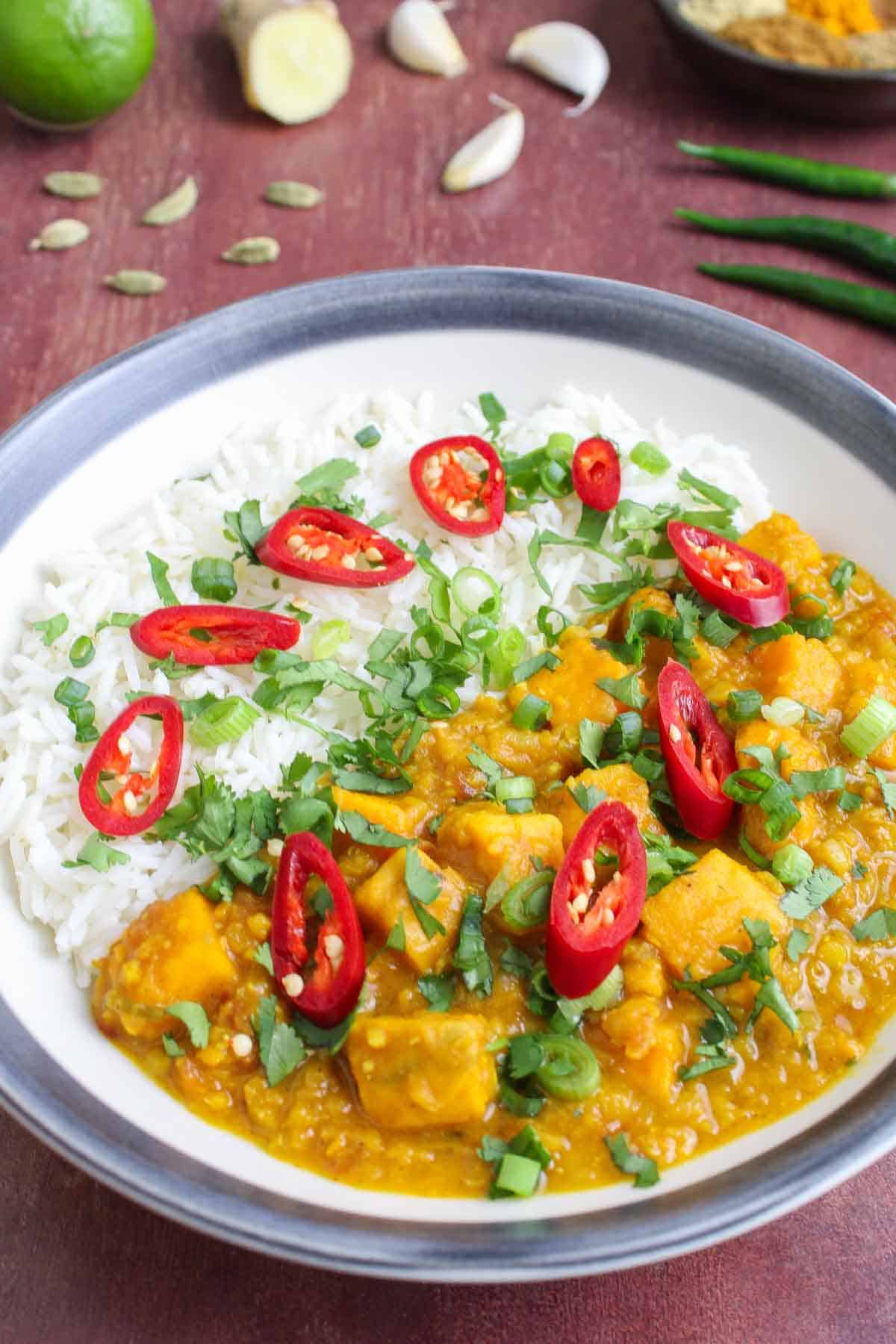 Soy-free sweet potato dal in bowl with rice, chilli, and coriander.