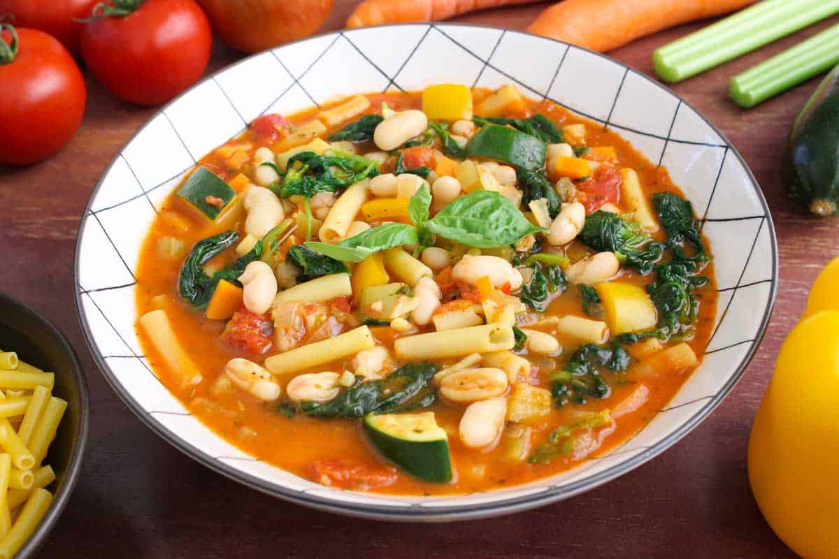 Hearty Minestrone Soup in Bowl with Fresh Basil