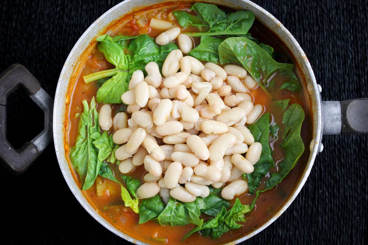 Process Shot – Adding Spinach and Cannellini Beans to Pan