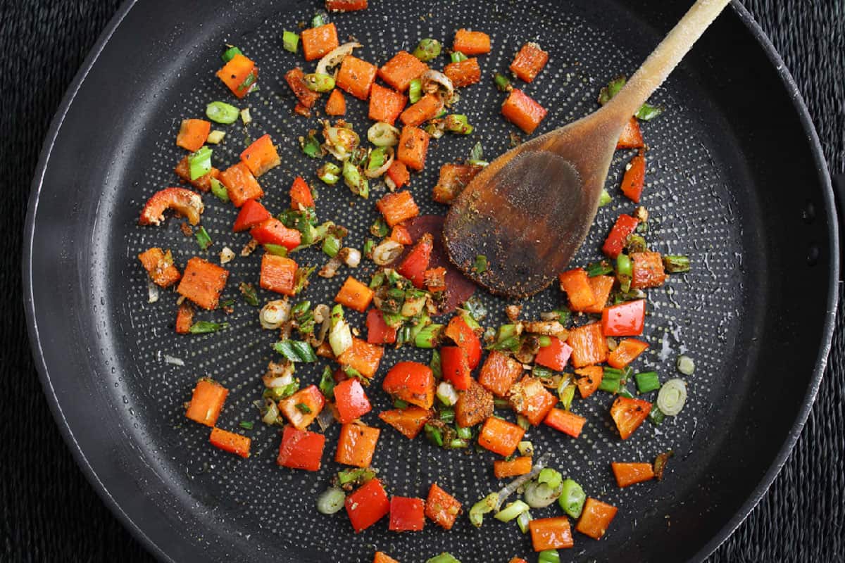 Recipe Process Shot – Adding Spices to Pan with Veg