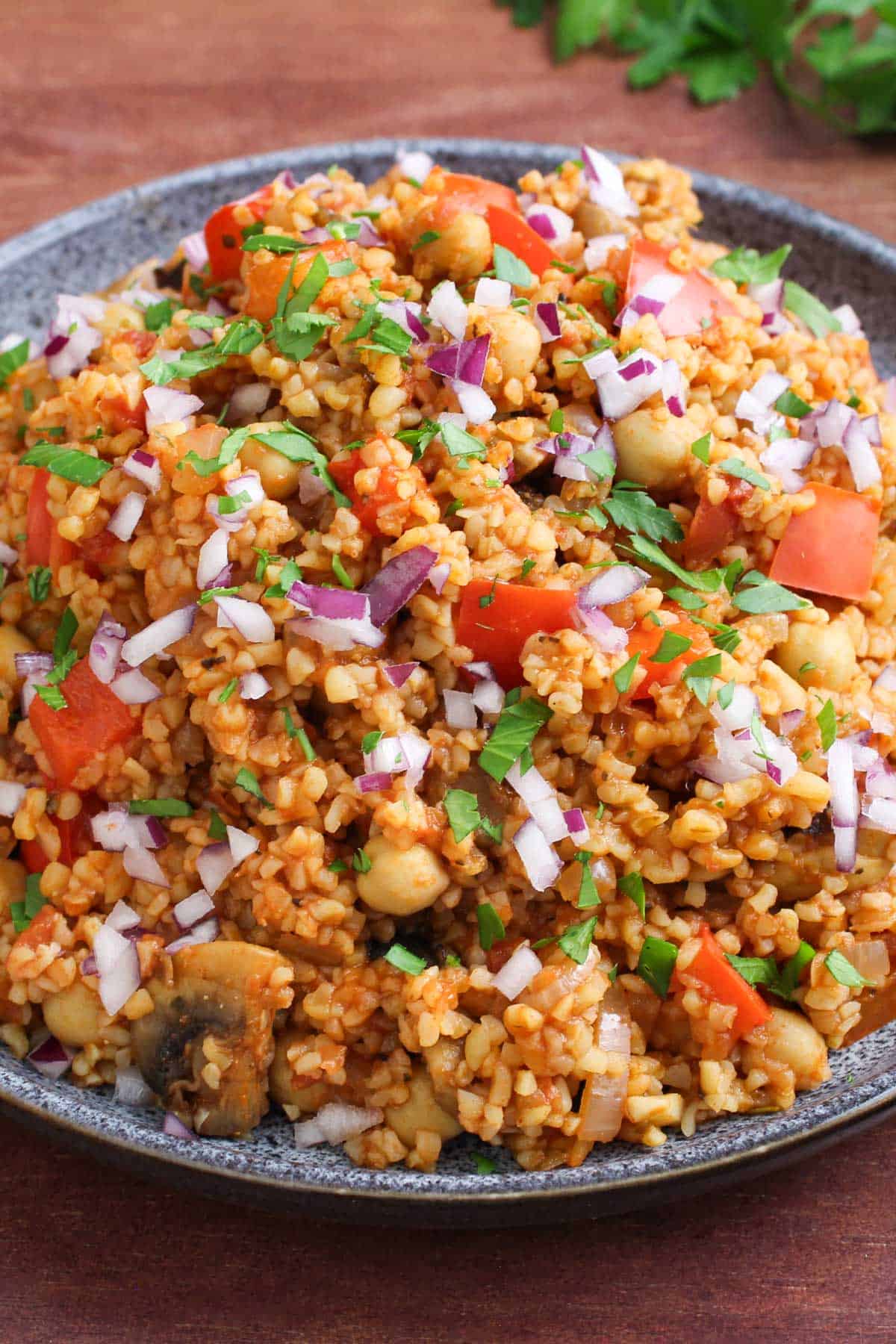 Vegan Bulgur Wheat Pilaf Topped with Red Onion and Parsley