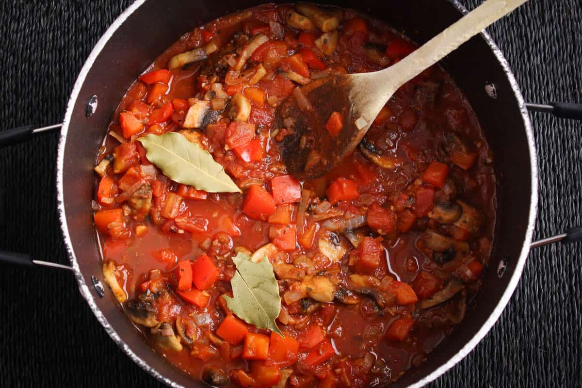 Recipe Process Shot – Adding Tomatoes and Seasonings to Pan