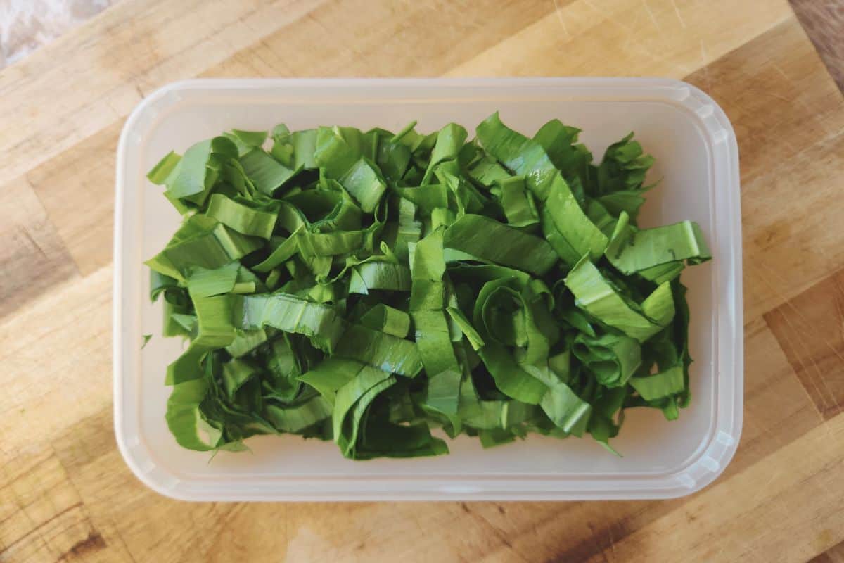 Overhead shot of chopped ramsons in plastic container