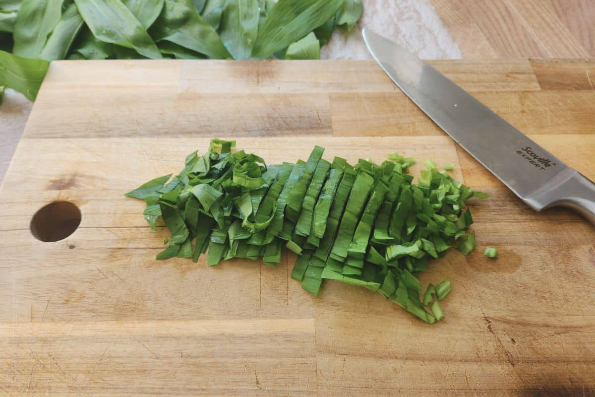 Chopped wild garlic leaves on chopping board