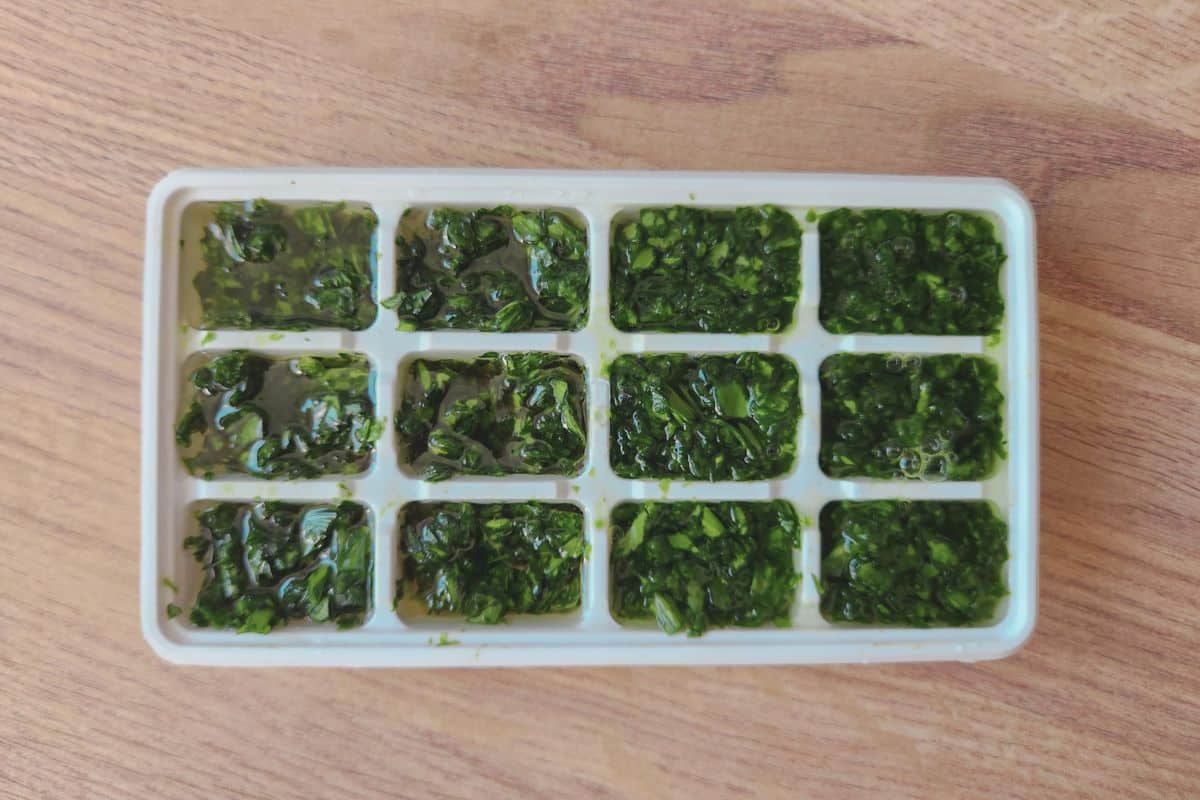 Topping up ice cube tray compartments with water or olive oil