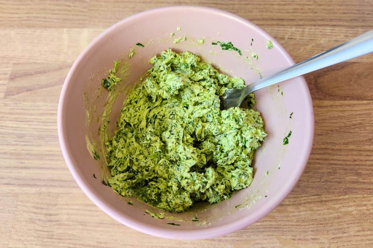 Mixing wild garlic butter in bowl with fork