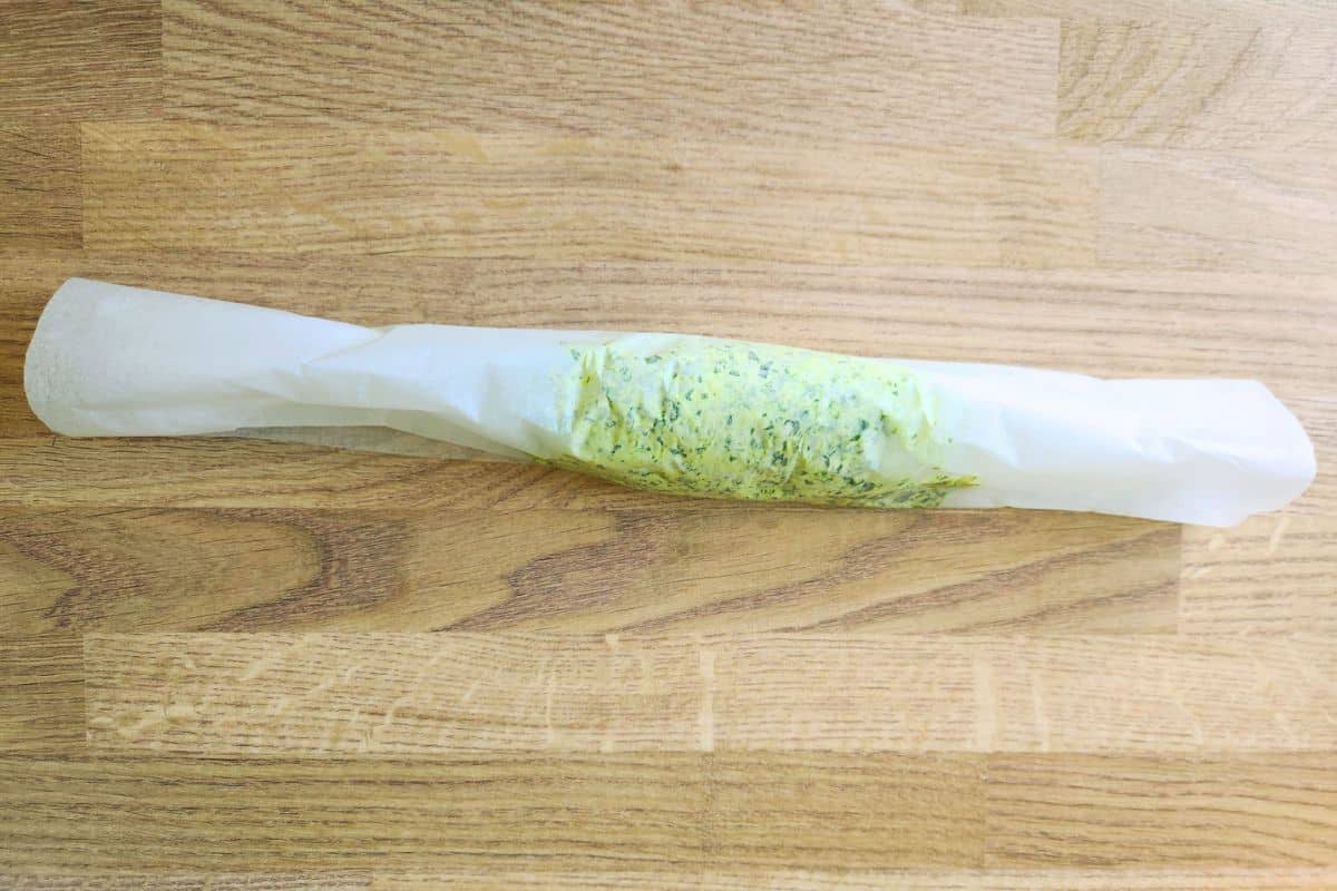 Rolling wild garlic butter mix into cylinder shape inside greaseproof paper