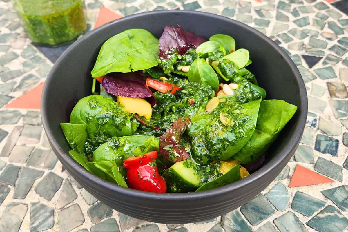 Close-up of salad in bowl dressed with wild garlic sauce