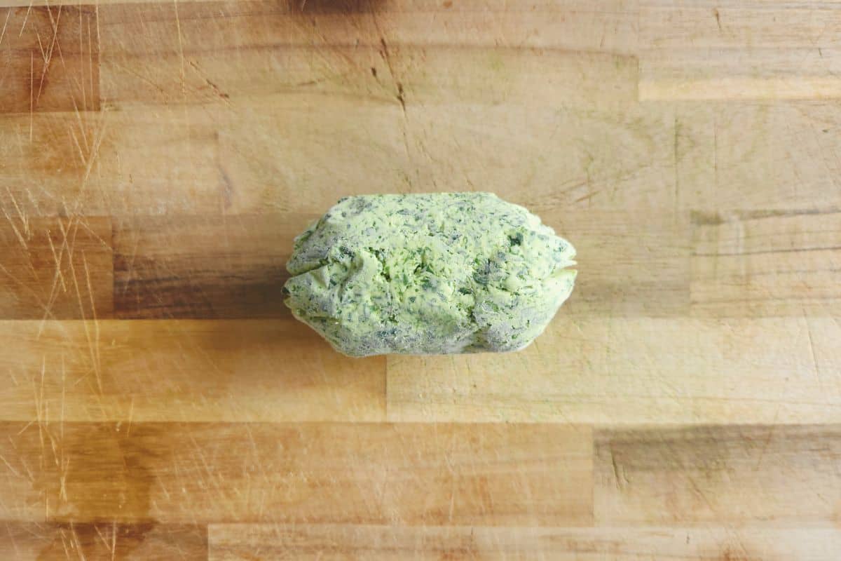 Frozen wild garlic butter log on board to defrost