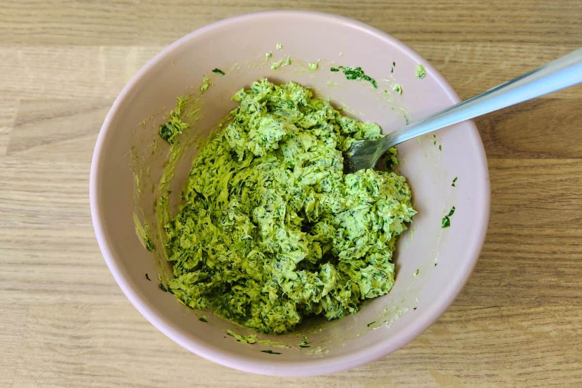 Mixing together wild garlic and butter using a fork