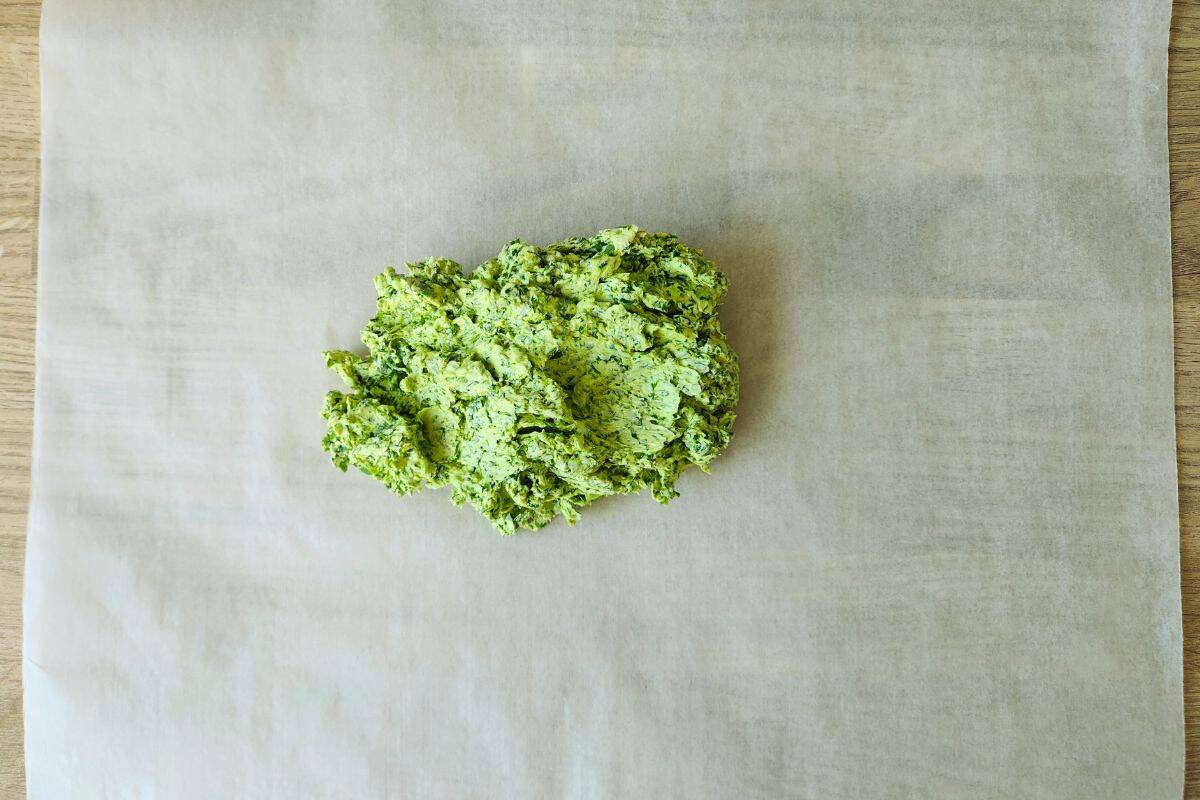 Spooning wild garlic butter mix onto greaseproof paper