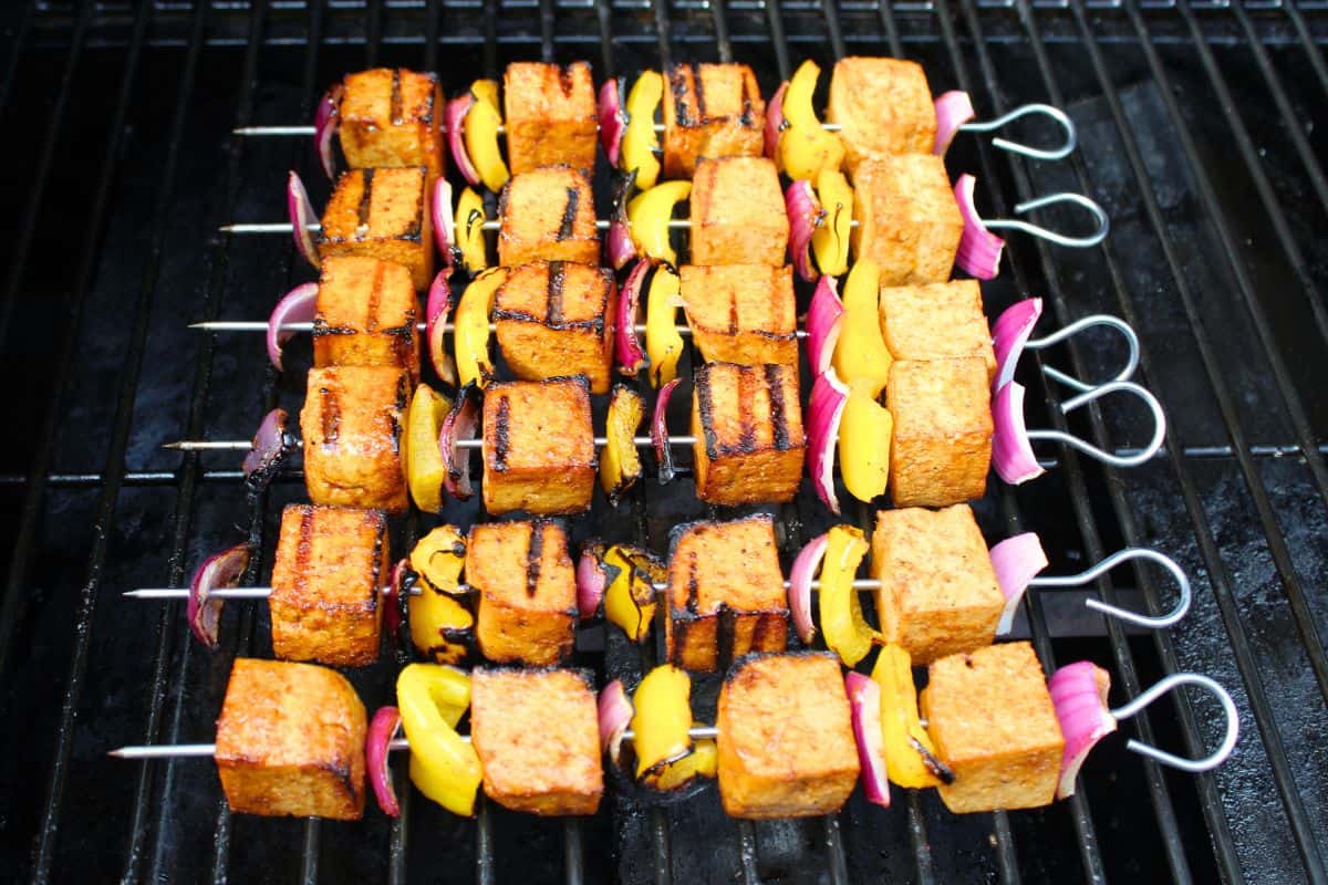 Tofu and vegetable skewers grilling on BBQ