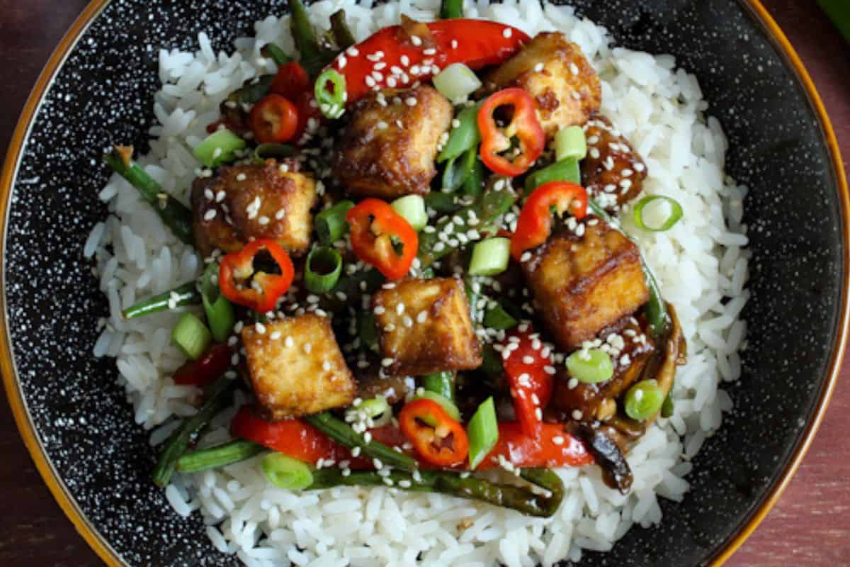 Crispy tofu stir-fry with rice in bowl