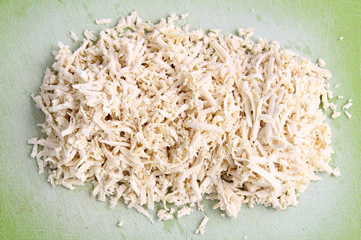 Grated tofu on chopping board