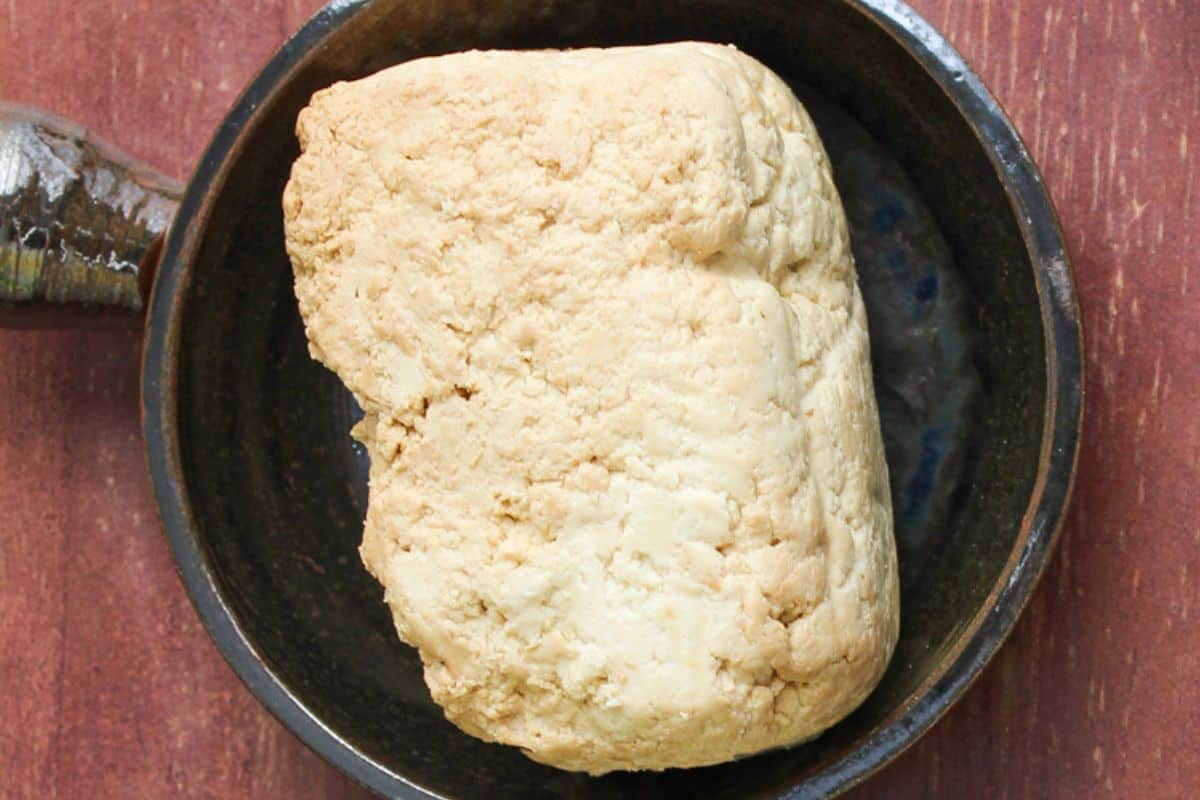 Block of extra-firm smoked tofu in small dish