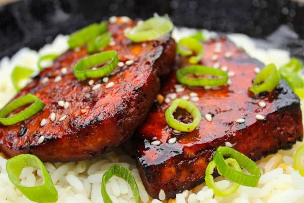 Grilled teriyaki tofu steaks on rice