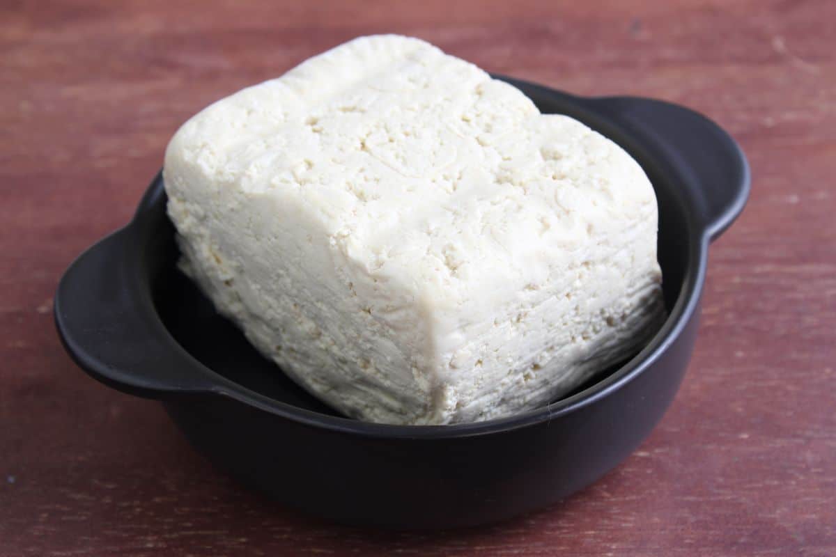 Block of extra-firm tofu in small bowl