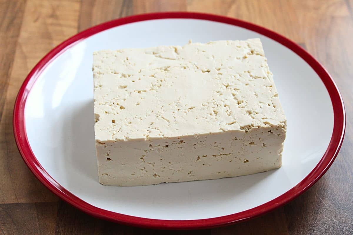 Block of firm tofu on plate