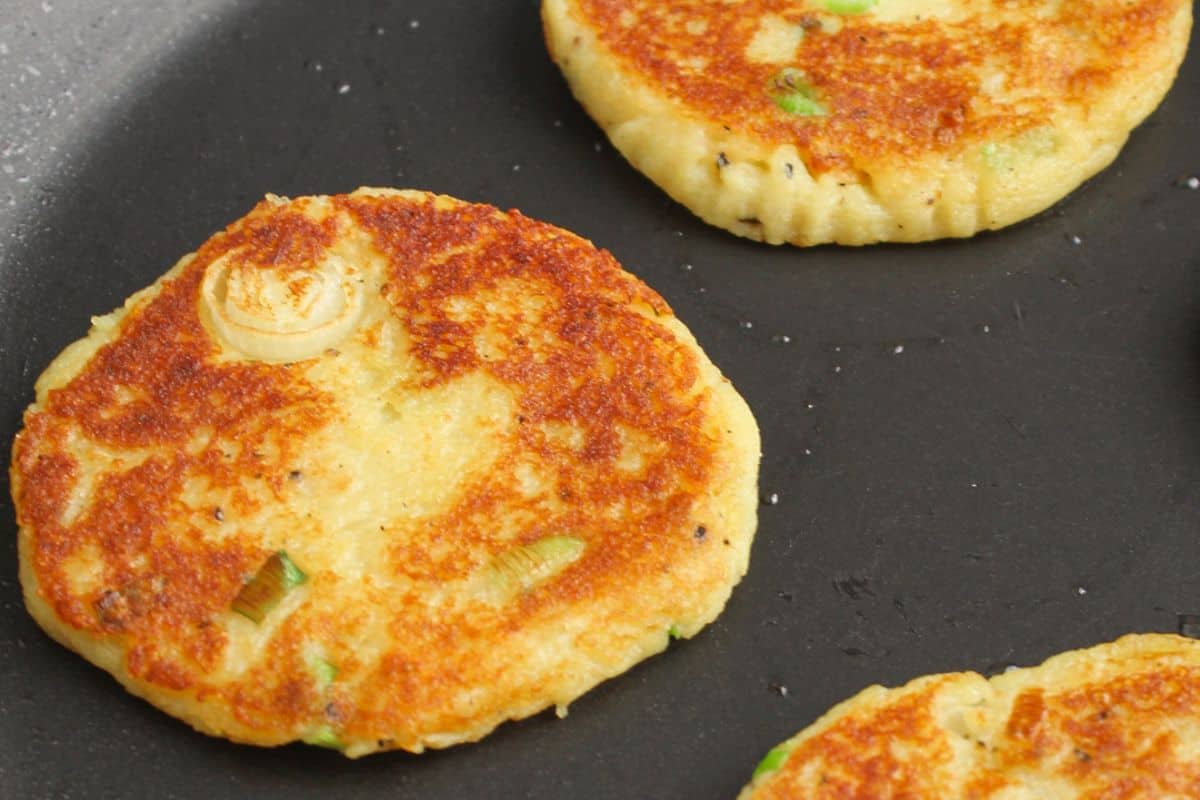 Leftover mashed potato fritters frying in pan