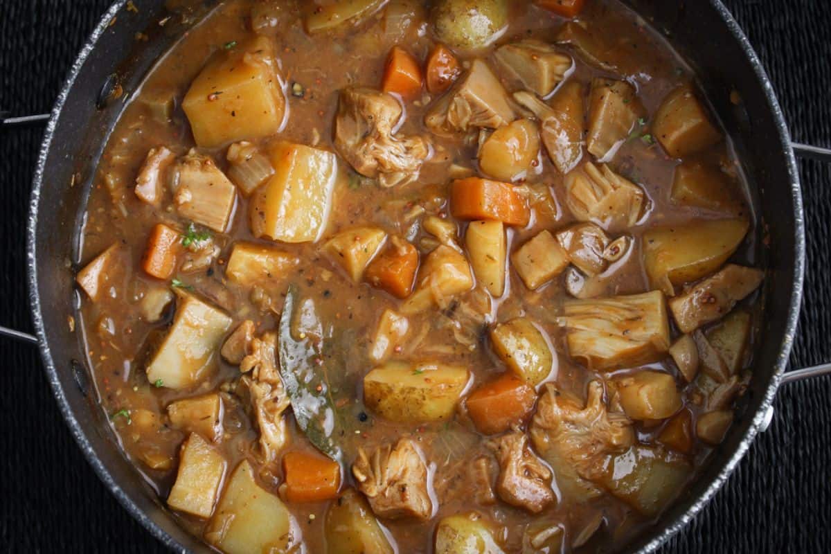 Vegan jackfruit and potato stew in pan overhead