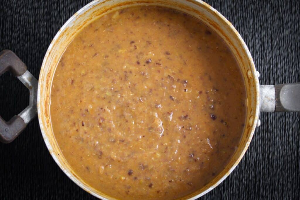 Black bean and potato soup in cooking pot