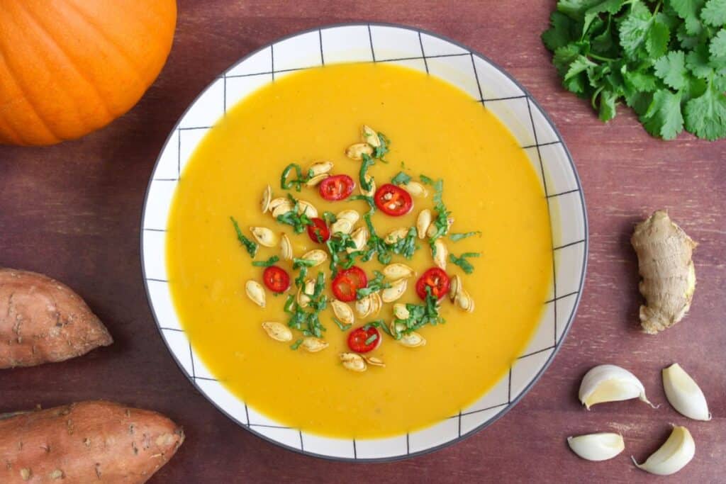 Pumpkin and sweet potato soup in bowl overhead